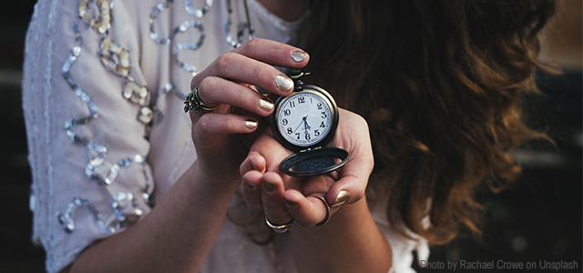 Woman showing pocket watch depicting ticking biological clock in women and time near menopause